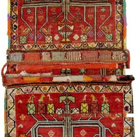 “Vintage Qashqai saddlebag with floral vase motif on red background” “Handwoven Persian saddlebag with tree and flower design” “Tribal Qashqai textile in red with decorative floral pattern” “Antique-style South Iranian saddlebag with botanical motif”