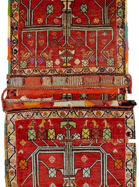 “Vintage Qashqai saddlebag with floral vase motif on red background” “Handwoven Persian saddlebag with tree and flower design” “Tribal Qashqai textile in red with decorative floral pattern” “Antique-style South Iranian saddlebag with botanical motif”