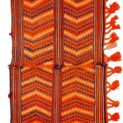 "Antique Qashqai Gahvareh cradle with pompons and tribal patterns" "Handwoven wool baby carrier from South Iran" "Traditional Persian dowry cradle textile" "Vintage tribal baby hammock from Qashqai tribe"