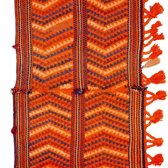"Antique Qashqai Gahvareh cradle with pompons and tribal patterns" "Handwoven wool baby carrier from South Iran" "Traditional Persian dowry cradle textile" "Vintage tribal baby hammock from Qashqai tribe"