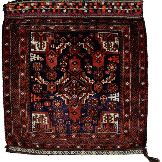 alt="Vintage Baluch tribal bag with dowry tufts and goat motifs" alt="Handwoven Baluch bag with red kilim S-design and flowerheads" alt="Antique Baluch wool bag with tribal symbolism from Northeast Iran" alt="Collectible Persian tribal bag with rich colours and unique details"
