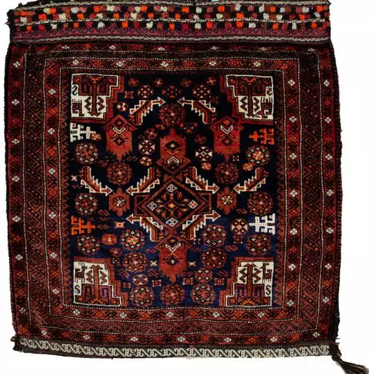 alt="Vintage Baluch tribal bag with dowry tufts and goat motifs" alt="Handwoven Baluch bag with red kilim S-design and flowerheads" alt="Antique Baluch wool bag with tribal symbolism from Northeast Iran" alt="Collectible Persian tribal bag with rich colours and unique details"