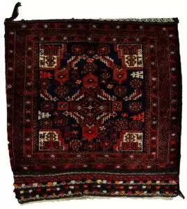 alt="Vintage Baluch tribal bag with dowry tufts and goat motifs" alt="Handwoven Baluch bag with red kilim S-design and flowerheads" alt="Antique Baluch wool bag with tribal symbolism from Northeast Iran" alt="Collectible Persian tribal bag with rich colours and unique details"