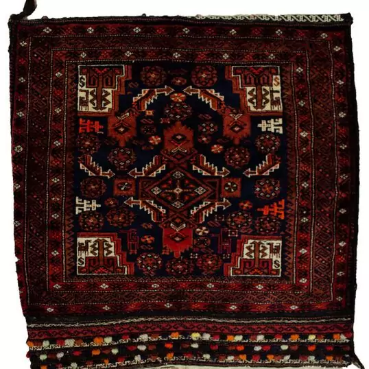 alt="Vintage Baluch tribal bag with dowry tufts and goat motifs" alt="Handwoven Baluch bag with red kilim S-design and flowerheads" alt="Antique Baluch wool bag with tribal symbolism from Northeast Iran" alt="Collectible Persian tribal bag with rich colours and unique details"