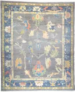 alt="Ushak rug with grey-blue field and bold floral motifs" alt="Handwoven Turkish Ushak rug with antique finish and petrol blue border" alt="Ushak rug with natural dyes and handspun wool in floral all-over design" alt="Grey blue Ushak carpet with vintage look for modern or classic interiors"