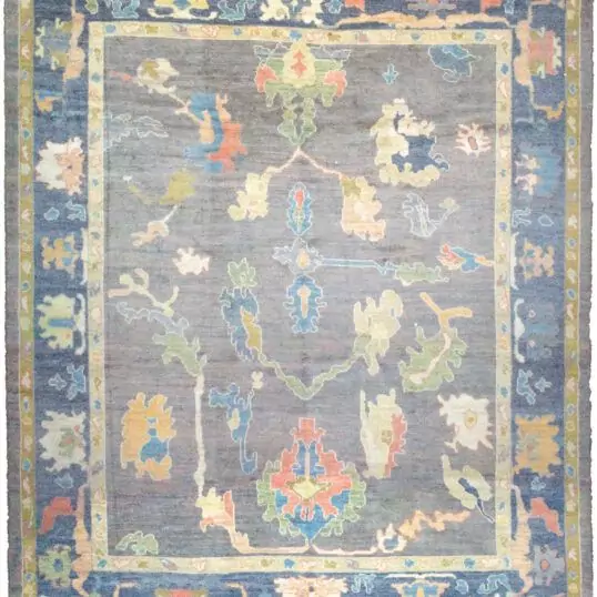 alt="Ushak rug with grey-blue field and bold floral motifs" alt="Handwoven Turkish Ushak rug with antique finish and petrol blue border" alt="Ushak rug with natural dyes and handspun wool in floral all-over design" alt="Grey blue Ushak carpet with vintage look for modern or classic interiors"