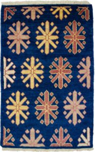 alt="Customisable modern-style Ushak mat with antique finish" alt="Indigo Ushak mat made with handspun wool and natural dyes" alt="Small antique-look rug in modern design, available to order" alt="Handmade Ushak accent mat with soft aged finish"