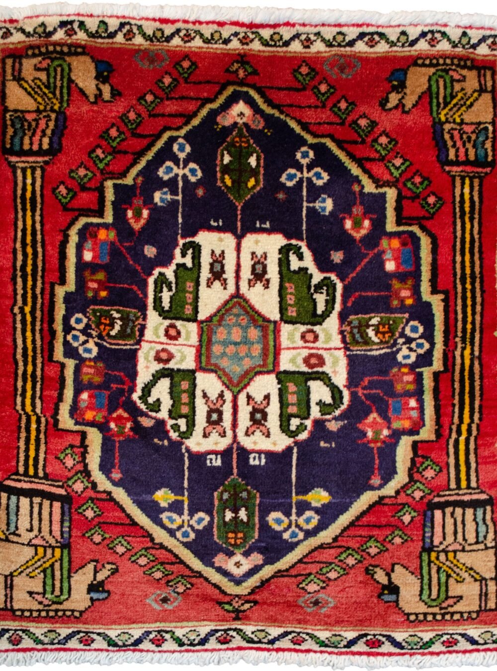 alt="Qashqai rug with Hashtgol medallion and Persepolis pillar design" alt="Persian tribal rug with horse-head pillar motif and paisley medallion" alt="Torki weave Qashqai rug with eight-paisley Hashtgol centre" alt="Hand-knotted Persian rug with classical and tribal motifs"