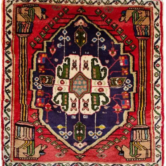 alt="Qashqai rug with Hashtgol medallion and Persepolis pillar design" alt="Persian tribal rug with horse-head pillar motif and paisley medallion" alt="Torki weave Qashqai rug with eight-paisley Hashtgol centre" alt="Hand-knotted Persian rug with classical and tribal motifs"