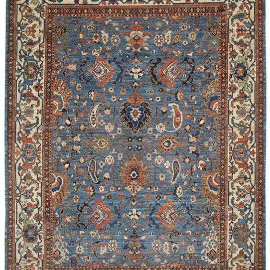 alt="Sultanabad-style rug with light blue field and cream border" alt="Persian production carpet with boteh and samovar motifs" alt="Antique-finish rug inspired by a Christie’s-sold original" alt="Decorative Persian rug with islimi and floral elements"