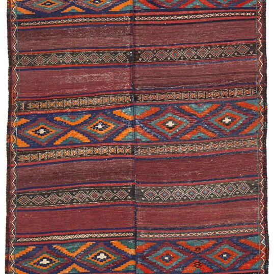 alt="Antique Baluch kilim from East Iran with lozenge motifs" alt="Finely woven tribal kilim in two sections sewn together" alt="Vintage Persian kilim with narrow bands and wide multicoloured patterns" alt="Baluch flatweave rug with symbolic lozenges and rich tribal character"