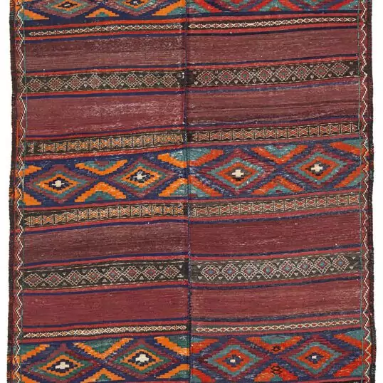 alt="Antique Baluch kilim from East Iran with lozenge motifs" alt="Finely woven tribal kilim in two sections sewn together" alt="Vintage Persian kilim with narrow bands and wide multicoloured patterns" alt="Baluch flatweave rug with symbolic lozenges and rich tribal character"
