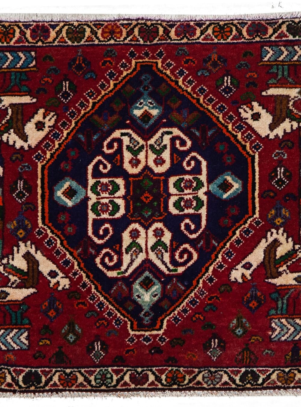 alt="Qashqai tribal mat with paisley and Persepolis pillar motifs" alt="Handwoven Persian mat with horse heads and central tablet design" alt="Small Qashqai rug with symbolic motifs and rich colours" alt="Vintage tribal mat from South Iran with cultural design"