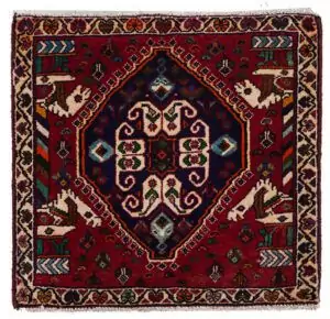 alt="Qashqai tribal mat with paisley and Persepolis pillar motifs" alt="Handwoven Persian mat with horse heads and central tablet design" alt="Small Qashqai rug with symbolic motifs and rich colours" alt="Vintage tribal mat from South Iran with cultural design"