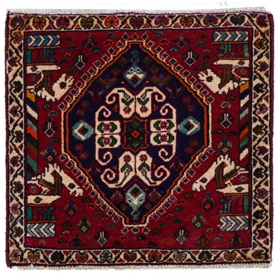 alt="Qashqai tribal mat with paisley and Persepolis pillar motifs" alt="Handwoven Persian mat with horse heads and central tablet design" alt="Small Qashqai rug with symbolic motifs and rich colours" alt="Vintage tribal mat from South Iran with cultural design"