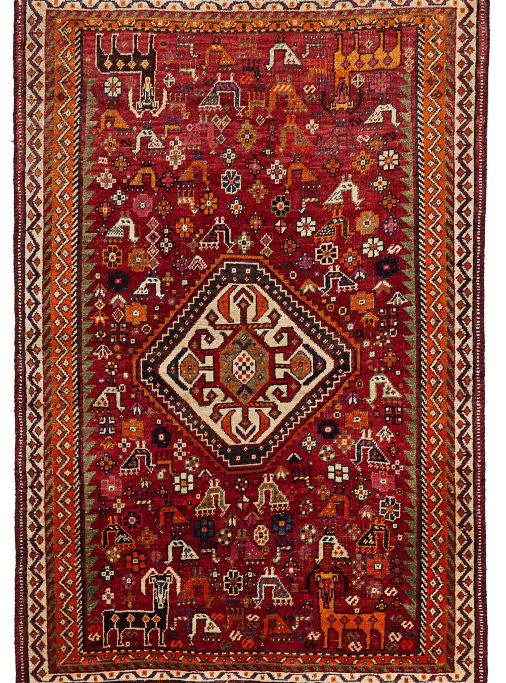 alt="Qashqai rug with red field, cream medallion, and tribal animal motifs" alt="Vintage Persian rug with peacocks, rams, and stylised flowers" alt="Fun Qashqai tribal rug from South Iran with narrow borders" alt="Characterful nomadic rug with symbolic animals and floral elements"