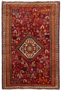 alt="Qashqai rug with red field, cream medallion, and tribal animal motifs" alt="Vintage Persian rug with peacocks, rams, and stylised flowers" alt="Fun Qashqai tribal rug from South Iran with narrow borders" alt="Characterful nomadic rug with symbolic animals and floral elements"