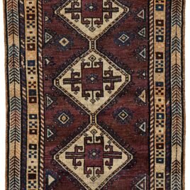 alt="Vintage Lori Behbahan rug with aubergine ground and triple medallion" alt="South Iranian tribal rug with plain field and characterful wear" alt="Decorative Persian rug in rare purple tones and simple layout" alt="Worn but elegant Lori Behbahan carpet with rich colour palette"