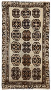 alt="Vintage Gabbeh rug with three octagons on aged cream background" alt="Worn tribal Persian rug with simple geometric motifs" alt="Gabbeh rug from South Iran with faded cream field and rustic charm" alt="Low pile antique Gabbeh with mellowed colours and octagon design"