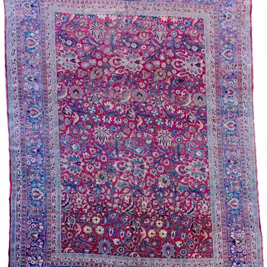 alt="Mashad carpet with maroon red field and floral palmette design" alt="Persian rug from Mashad with blue floral borders and vines" alt="High-quality wool Mashad rug with palmettes and natural dyes" alt="Traditional Persian carpet with red ground and elegant floral detailing"
