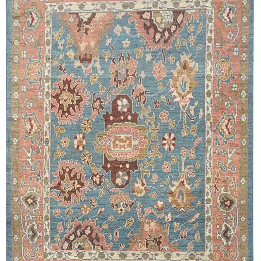 alt="Light blue Ushak carpet with random stylised floral motifs" alt="Decorative Turkish rug with peach border and cream guard accents" alt="Ushak carpet with geometric floral design and natural dye wool" alt="Modern Ushak rug with antique aesthetic and soft blue ground"