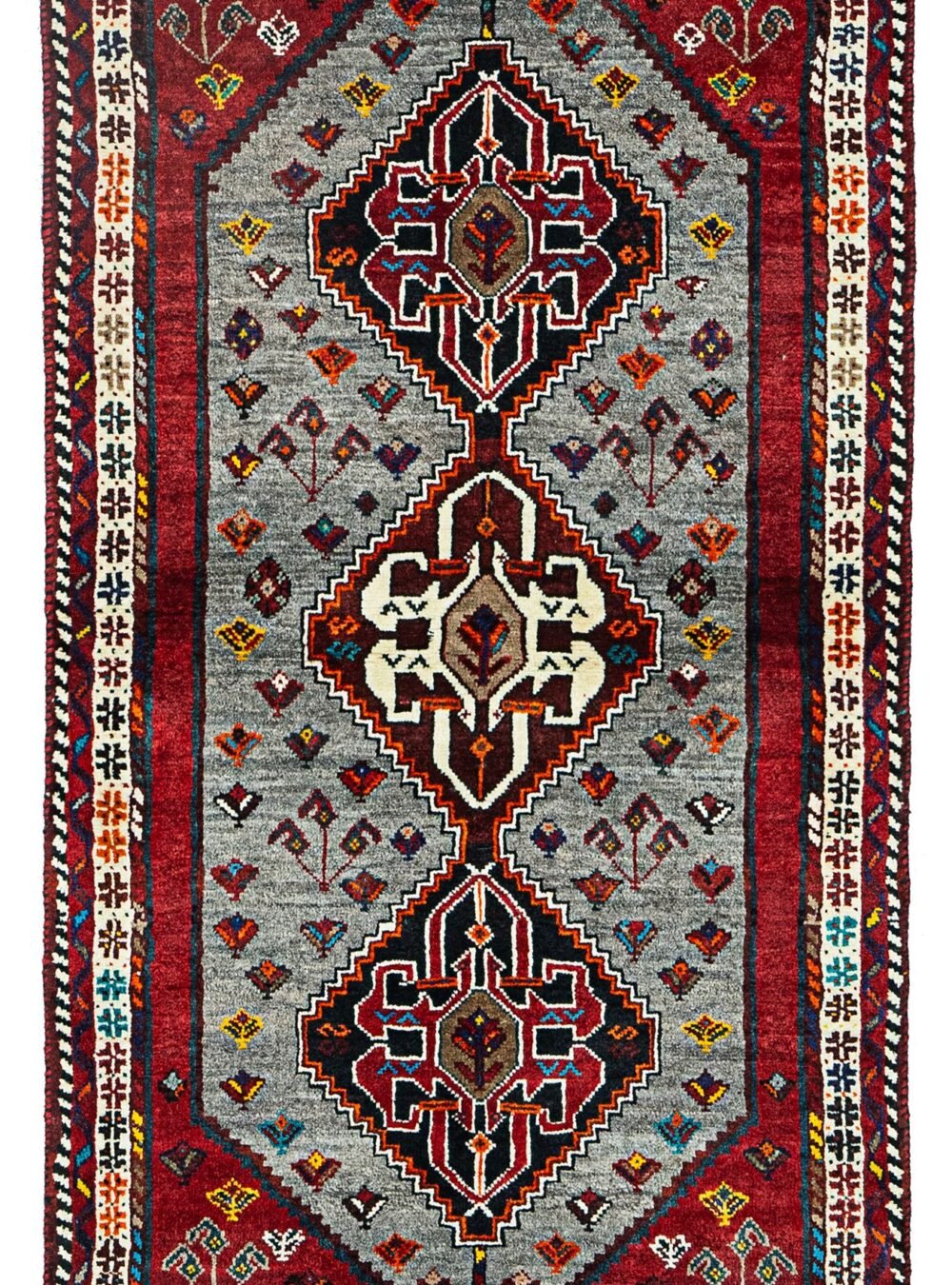 alt="Grey-ground Qashqai rug with scarab beetle medallions and red border" alt="Tribal Persian rug with cream central medallion and abrushed field" alt="Handwoven Qashqai wool rug with symbolic motifs and natural dyes" alt="Rare Qashqai carpet with scarab design and elegant colour contrast"