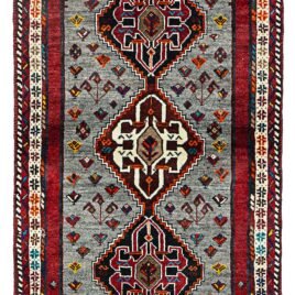 alt="Grey-ground Qashqai rug with scarab beetle medallions and red border" alt="Tribal Persian rug with cream central medallion and abrushed field" alt="Handwoven Qashqai wool rug with symbolic motifs and natural dyes" alt="Rare Qashqai carpet with scarab design and elegant colour contrast"
