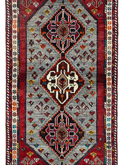 alt="Grey-ground Qashqai rug with scarab beetle medallions and red border" alt="Tribal Persian rug with cream central medallion and abrushed field" alt="Handwoven Qashqai wool rug with symbolic motifs and natural dyes" alt="Rare Qashqai carpet with scarab design and elegant colour contrast"
