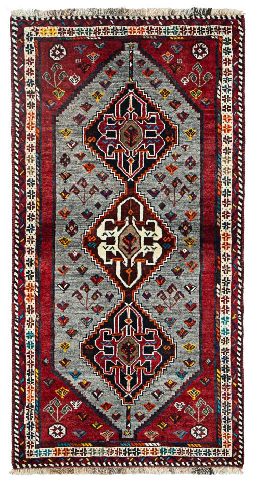 alt="Grey-ground Qashqai rug with scarab beetle medallions and red border" alt="Tribal Persian rug with cream central medallion and abrushed field" alt="Handwoven Qashqai wool rug with symbolic motifs and natural dyes" alt="Rare Qashqai carpet with scarab design and elegant colour contrast"