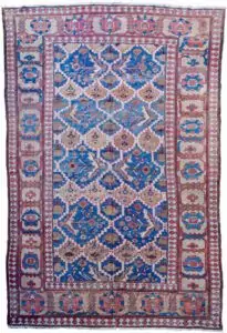 alt="Bakhshayesh carpet with blue field and all-over bush design" alt="Persian rug with lozenge bands and geometric light brown border" alt="Rare Bakhshayesh carpet with tribal bush motifs and decorative colors" alt="Traditional Persian rug from Northwest Iran with unique all-over pattern"