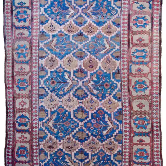 alt="Bakhshayesh carpet with blue field and all-over bush design" alt="Persian rug with lozenge bands and geometric light brown border" alt="Rare Bakhshayesh carpet with tribal bush motifs and decorative colors" alt="Traditional Persian rug from Northwest Iran with unique all-over pattern"