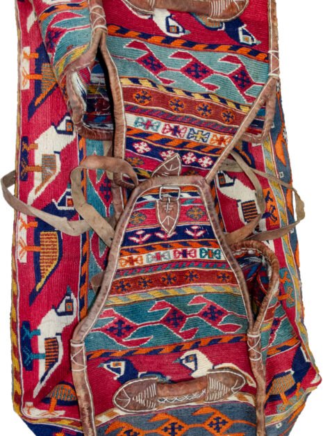 alt="Qashqai Rakhtekhab bag with sumak weave, partridges, goats, and leather trim" alt="Vintage tribal Mafrash bag in turquoise, red, blue, and orange with intact handles" alt="Sumak-woven nomadic bedding bag with animal motifs and collector value" alt="Traditional Qashqai storage bag repurposable as ottoman or table base"
