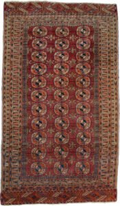 alt="Antique Turkmen rug with elephant foot motif and rust field" alt="Tribal rug with two-tone background and geometric borders" alt="Vintage Turkmen carpet in good condition with low pile" alt="Central Asian rug with elephant foot guls and traditional design"