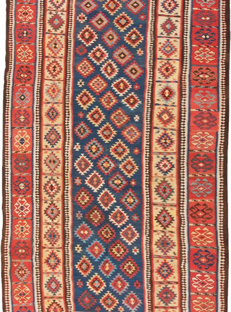 alt="Antique Shirvan kilim with blue ground and lozenge motifs" alt="Shirvan kilim with evil eye red border and yellow inner frame" alt="Caucasian flatweave with multicoloured lozenges and symbolic motifs" alt="Restored antique Shirvan kilim with tribal design and bold colours"