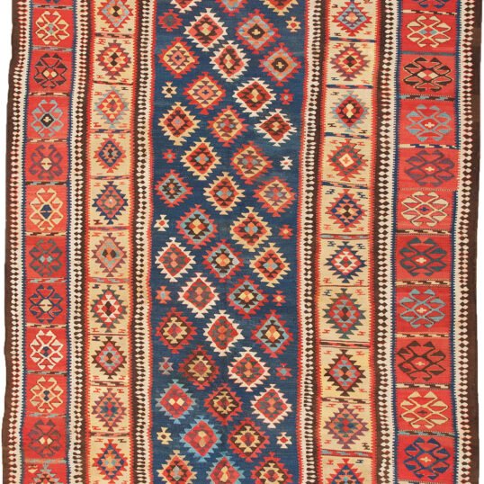 alt="Antique Shirvan kilim with blue ground and lozenge motifs" alt="Shirvan kilim with evil eye red border and yellow inner frame" alt="Caucasian flatweave with multicoloured lozenges and symbolic motifs" alt="Restored antique Shirvan kilim with tribal design and bold colours"