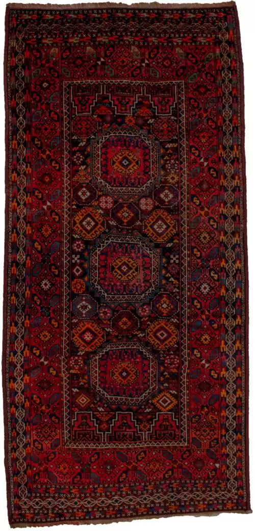 alt="Antique Baluch rug with elephant foot design and deep red tones" alt="Tribal Baluch rug with S motifs and multicoloured outer border" alt="Handwoven Baluch carpet with rare red hue and geometric centrepiece" alt="Collector’s Baluch rug featuring elephant foot and tribal patterns"