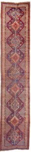 alt="Antique Khamseh runner with light blue ground and tribal motifs" alt="Persian tribal runner with birds, dogs, and medallions" alt="Rare Khamseh rug from South Iran with floral and animal motifs" alt="Vintage narrow Khamseh rug with central medallions on blue field"
