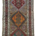“Antique Kordi runner with grey-brown ground and red borders” “Persian tribal rug with medallion design and white guard borders” “Handwoven Kurdish runner with unique earthy colour palette” “Vintage Persian runner for hallway or corridor décor”