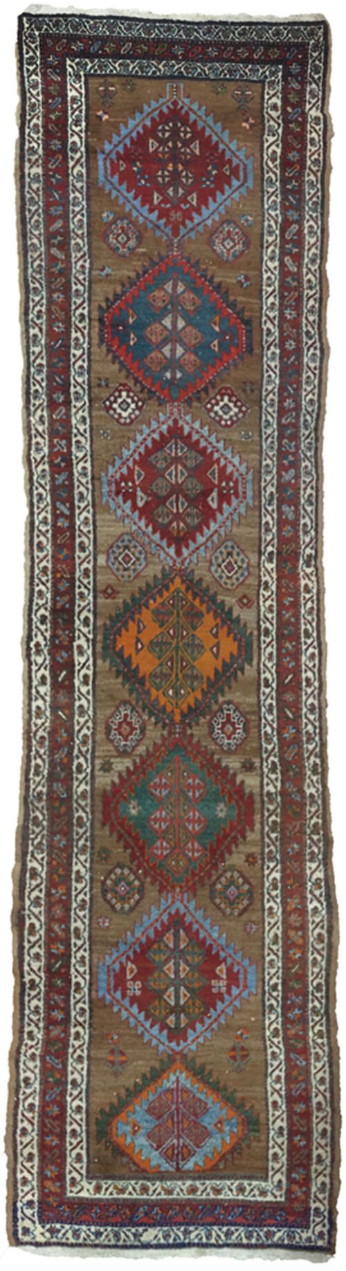 “Antique Kordi runner with grey-brown ground and red borders” “Persian tribal rug with medallion design and white guard borders” “Handwoven Kurdish runner with unique earthy colour palette” “Vintage Persian runner for hallway or corridor décor”