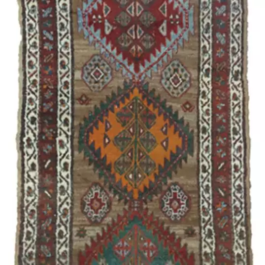 “Antique Kordi runner with grey-brown ground and red borders” “Persian tribal rug with medallion design and white guard borders” “Handwoven Kurdish runner with unique earthy colour palette” “Vintage Persian runner for hallway or corridor décor”