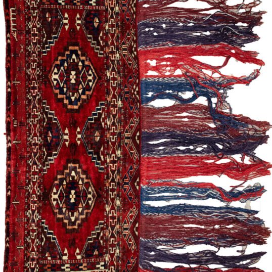 Vintage Turkmen Tobreh with deep red field Tasselled edge of antique Turkmen tribal bag Close-up of end motifs on Turkmen Tobreh Blood red wool Tobreh from Northeast Iran Collectible Turkmen nomadic storage bag