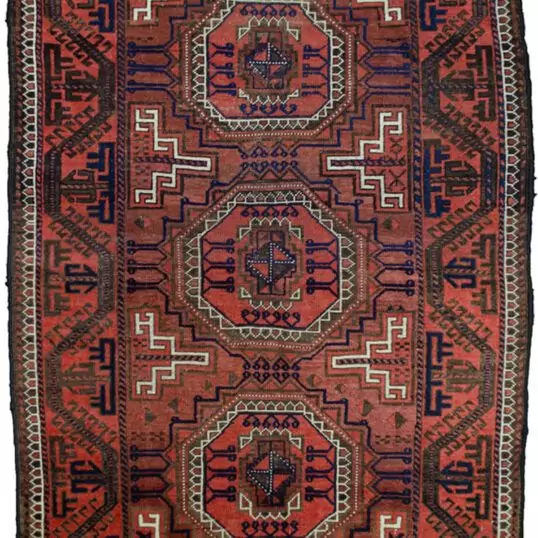 alt="Antique Baluch rug from Northeast Iran with terracotta ground and medallions" alt="Baluch tribal rug with eight-sided medallions and geometric border" alt="Vintage Persian Baluch carpet with maturing red hues and natural dyes" alt="Terracotta Baluch rug with traditional tribal motifs