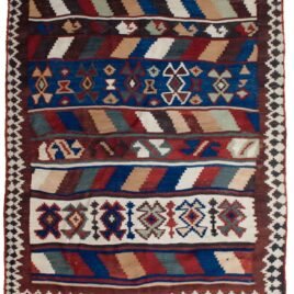 alt="Tribal kilim with bold central motifs and cream geometric border" alt="Handwoven wool kilim with multicoloured striped ends" alt="Decorative tribal kilim with traditional patterns and colourful finish" alt="Flatweave kilim with tribal design and balanced layout"