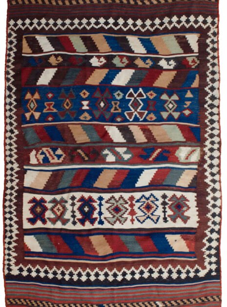 alt="Tribal kilim with bold central motifs and cream geometric border" alt="Handwoven wool kilim with multicoloured striped ends" alt="Decorative tribal kilim with traditional patterns and colourful finish" alt="Flatweave kilim with tribal design and balanced layout"