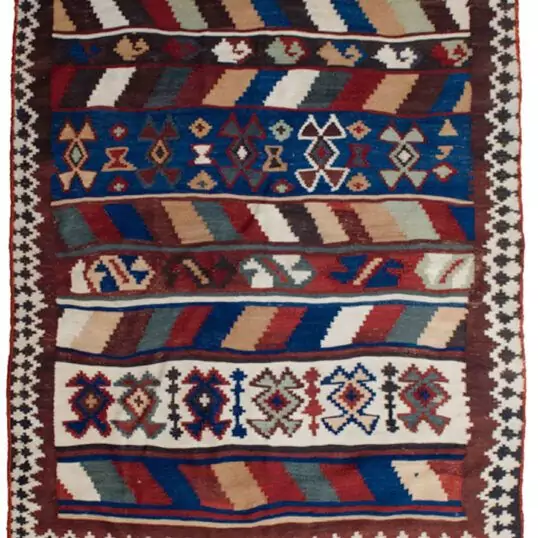 alt="Tribal kilim with bold central motifs and cream geometric border" alt="Handwoven wool kilim with multicoloured striped ends" alt="Decorative tribal kilim with traditional patterns and colourful finish" alt="Flatweave kilim with tribal design and balanced layout"