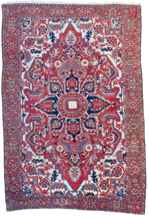 alt="Gharadagh Heriz carpet with red ground and bold medallion" alt="Vintage Persian rug with Samavar border and white spandrels" alt="Large Heriz rug with stylised floral design from Northwest Iran" alt="Restored antique Heriz carpet with bold colours and classic motifs"