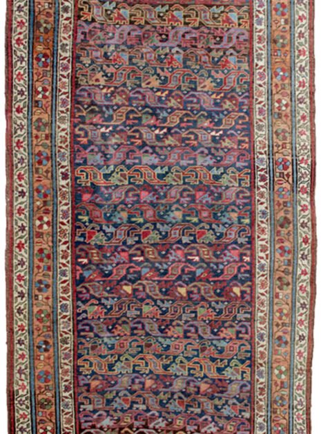 “Antique Bijar runner with blue field and apricot floral border” “Handwoven Persian rug with low pile and wool foundation” “Elegant narrow Bijar rug for hallway or corridor” “Densely woven antique Bijar runner from West Iran”