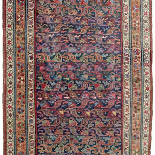 “Antique Bijar runner with blue field and apricot floral border” “Handwoven Persian rug with low pile and wool foundation” “Elegant narrow Bijar rug for hallway or corridor” “Densely woven antique Bijar runner from West Iran”