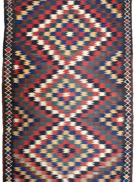 alt="Antique Varamin kilim rug with eye dazzler design from Central Iran" alt="Room-size Persian kilim with geometric lozenge border and tribal motif" alt="Rare Varamin kilim with weaver's mark and traditional flatweave" alt="Collectible Persian flatweave rug in earthy tones with bold design"