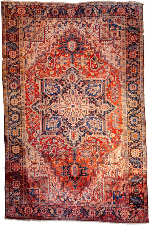alt="Heriz carpet with bold medallion and terracotta red ground" alt="Persian rug with white spandrels and geometric design" alt="Classic Heriz rug with flowing border and good pile" alt="Antique Heriz carpet with minor wear and strong colours"